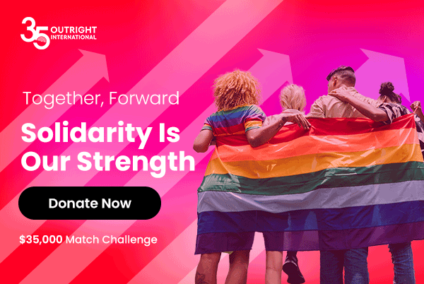 People holding a Pride flag for year-end giving